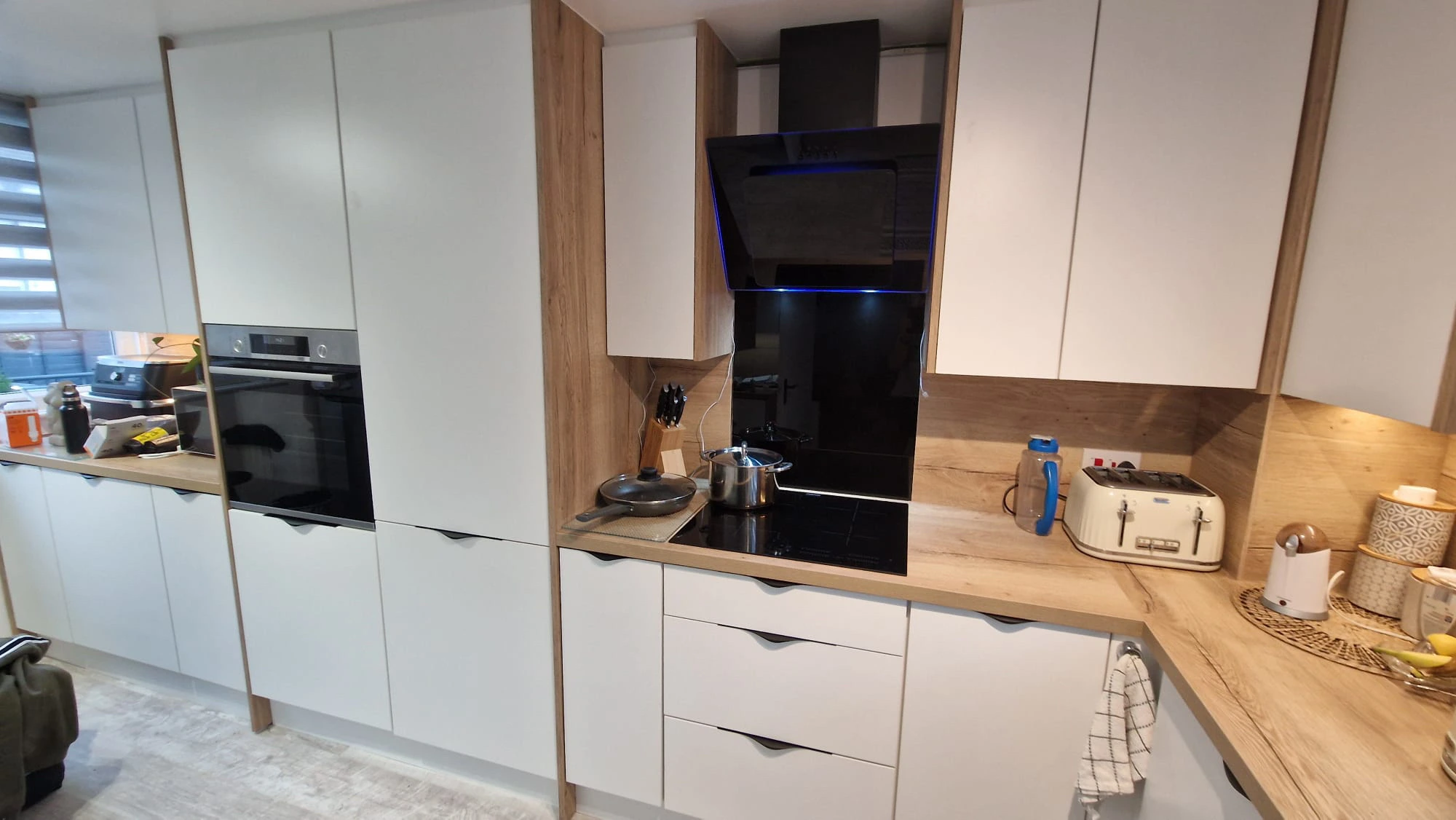 Modern white and wood kitchen with black angled extractor